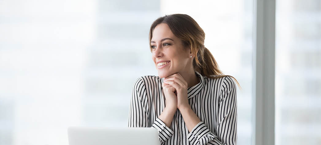 Happy confident businesswoman received good, successful, joyful news at workplace, win, motivated satisfied smiling woman employee sitting behind laptop. Head shot portrait.