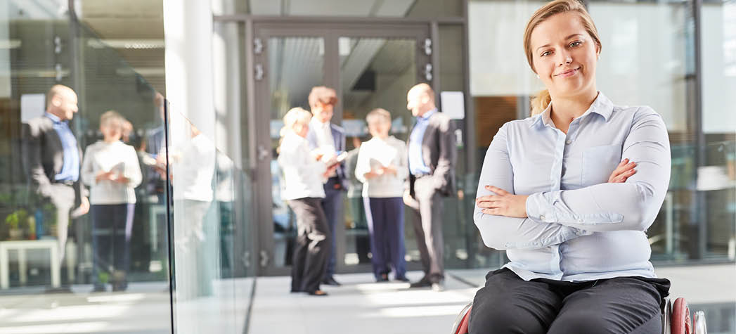 Young business woman in a wheelchair with crossed arms for business inclusion