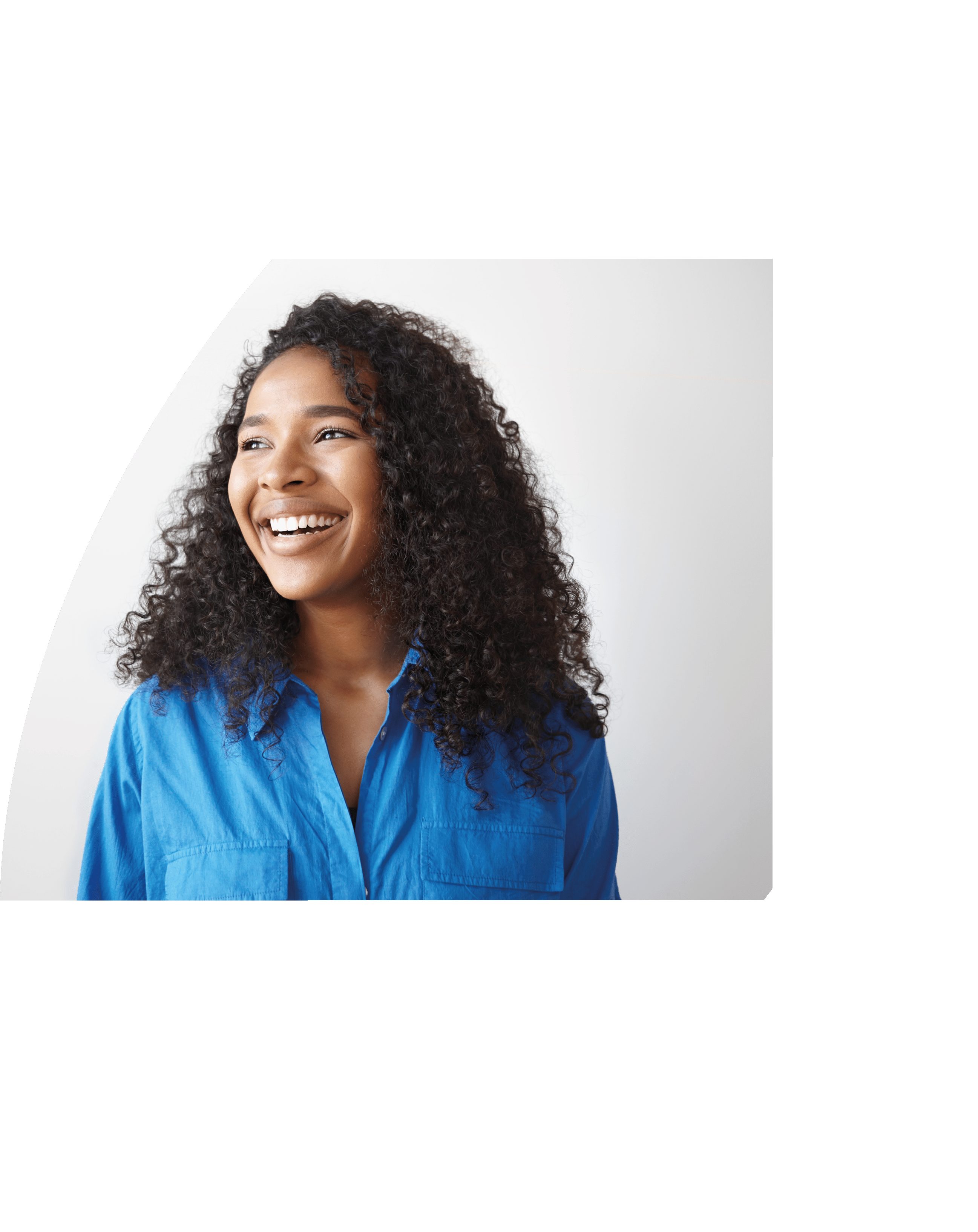 Positive human facial expressions, emotions, reaction and feelings. Attractive young dark skinned female with voluminous hairstyle laughing at joke, looking away, showing white perfect teeth