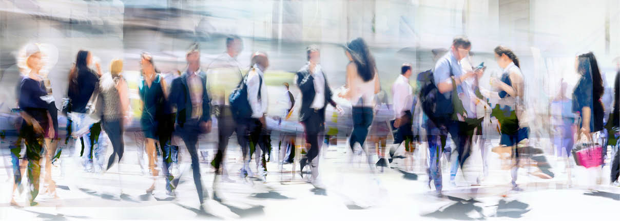 Walking people blur. Lots of people walking in the City of London. Wide panoramic view of people crossing the road.